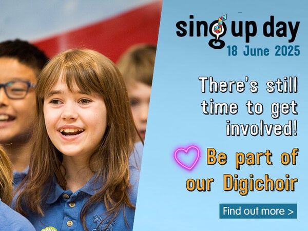  A banner for "Sing Up Day 18 June 2025" shows a smiling child with long brown hair in a blue collared shirt, singing with other blurred children next to them. On the right, white text on a light blue background reads: "There's still time to get involved! Be part of our Digichoir". A pink heart icon is next to "Be part of". Below this, a blue button says "Find out more >